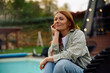 © Drazen - Carefree woman enjoying in spring day while relaxing in backyard.