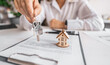 © Aboltin - Woman real estate agent gives keys paperwork and miniature house model. Concept of buying apartment, rental contract signing, trusted agency service and modern housing ownership.