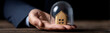 © pattozher - Protected Home: A conceptual shot presents a miniature house enclosed within a transparent barrier, cradled gently in the palm of a hand, symbolizing safety, security and real estate protection.