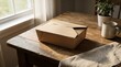 © Armando Loho - Brown paper takeaway food box sitting on a rustic wooden table at home