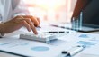 © Yultoms95 - Business person using calculator with virtual tax dashboard, representing digital tax planning, financial calculation, and strategic income management in modern finance.