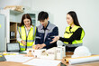 © Nuttapong punna - Three Asian architects discussing building model and blueprint. Architecture design, construction planning, teamwork and project management