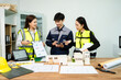 © Nuttapong punna - Three Asian architects discussing building model and blueprint. Architecture design, construction planning, teamwork and project management