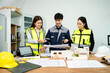 © Nuttapong punna - Three Asian architects discussing building model and blueprint. Architecture design, construction planning, teamwork and project management