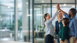 © Sukifli Dakheng - Diverse business team high five celebrating success
