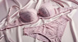 © Suta - Embrace the delicate allure of a beautiful pink lace lingerie set, featuring a stylish bra and comfortable panties, artfully arranged on a silky surface, symbolizing elegance and intimate luxury