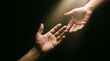 © antor - Two hands reaching out towards each other in a beam of light with reaching connection darkness offering receiving friendship togetherness assistance spiritual understanding stranger