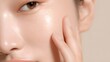© oksanatukane - close-up of healthy glowing skin with clear texture and hydration. Radiant asian or korean woman applies moisturizer serum for a beauty routine. smooth dermatology treatment results.