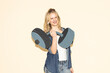 © VISTA by Westend61 - Smiling model in denim outfit lifting fake paper dumbbell