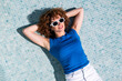 © VISTA by Westend61 - Model relaxing in an empty swimming pool in Granada during summer
