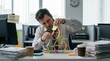© Coosh448 - Office worker building a house of cards with sticky notes, procrastination, workplace pressure and playful stress concept for editorial storytelling, mental health campaigns and business culture