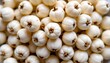 © MakeitEasy - The image features a close up view of a large collection of small, round, white vegetables or bulbs, densely packed together