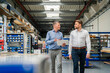 © BusinessClass by W61 - Manager and engineer with tablet talk in production hall