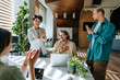 © BusinessClass by W61 - Smiling colleagues applauding happy businessperson in modern office