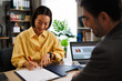 © djile - Asian businesswoman signing contract in office meeting