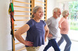 © Robert Kneschke - Senior Adults Exercising in Rehabilitation Center Lunges and Physical Therapy for Recovery and Wellness Indoor Gym Setting With Equipment
