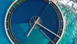 © SolaruS - Stunning aerial perspective of a circular industrial water plant by the turquoise sea. A perfect metaphor for sustainability, blue economy, and modern marine engineering solutions.