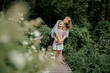 © Vlad - Cute child is playing with her mom in the garden. Family time.