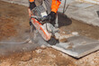 © Iryna - Worker uses concrete cutter to shape slab on construction site during daytime work hours