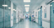 © Vhagar - A blurred view of a hospital corridor, illustrating the busy, clinical environment often found in healthcare facilities.