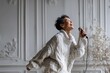 © Markus Schröder - Portrait of a glad asian woman in her 50s dancing and singing song in microphone over scandinavian-style interior background