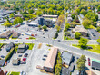 © Will - Aerial view of a busy city intersection with crosswalks, traffic signals, and urban road infrastructure.