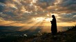 © Mateus - Jesus Silhouette with Light Rays Through Clouds Calm Spiritual Background