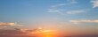 © Choat - Panoramic sunset sky background with vibrant orange and golden clouds under a soft blue twilight sky