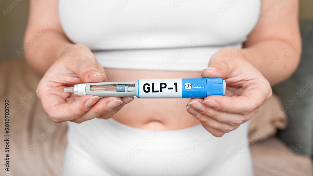 Glp Needle GLP-1 injection pen in female hands near abdomen, weight loss and ...