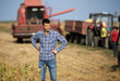 © Budimir Jevtic - Farmer standing in front of combine harvester