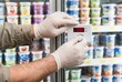 © Stitch - Grocery store worker hands in gloves adjusting the temperature dial on a commercial refrigerator display
