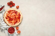 © Pixel-Shot - Pizza dough with tasty sauce and tomatoes on light background