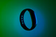 © Artly Studio - futuristic smart wristband glowing with neon blue lights on dark gradient background