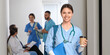 © Pixel-Shot - Female medical intern with coffee cup and clipboard in hall