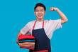 © Gatot - Portrait of Confident Young Laundry Worker Showing Muscle Strength