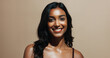 © peopleimages.com - Portrait, skincare and happy woman in studio, shine and natural dermatology on brown background. Confidence, smile and person with beauty cosmetics for glow, wellness and self care for healthy skin