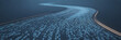 © MSTTASLIMA - Digital data stream flowing through a futuristic curved pathway with blue binary code on a dark background