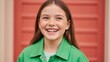 © NN AI - Laughing young girl with freckles in green jacket. Happy child portrait against red background. Childhood and joy concept