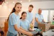 © Ljustina - Volunteers working together packing donation boxes at charity center