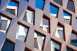 © yaqui_villegas - Angles and colorful windows shape an abstract pattern on a modern facade as geometry and architecture merge into graphic design details