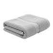 © karina - A neatly folded light grey terry cloth towel with a prominent ribbed texture against a stark black background.