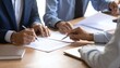 © SolaruS - Business partners in professional suits sign official contracts at a wooden desk, capturing a moment of successful collaboration, legal agreement, and formal corporate growth strategies.