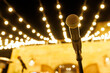 © 9parusnikov - Professional microphone on a stand with festive bokeh lights