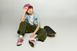 © LIGHTFIELD STUDIOS - Stylish kid showcasing vibrant fashion with skateboard in a modern setting