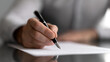 © Kanomaoi - Close up of a person hand's signing a real estate property sale contract