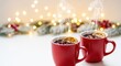 © Chanchai - Two ceramic mugs filled with hot mulled wine emit gentle steam against a soft bokeh background of twinkling lights and winter decorations, spices, cozy, wine
