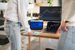 © Studio Marmellata - Two people analyze financial charts on multiple screens, discussing market trends and investment strategies at a modern desk.