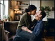 © hampura - Romantic Couple Sharing Intimate Moment on Sofa at Home