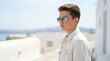 © Len_mik - Young man in casual attire with a contemplative mood gazing into the distance against a sunny coastal backdrop with copy space