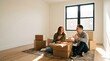 © ArtShop - Young couple enjoying pizza while unpacking boxes in new home